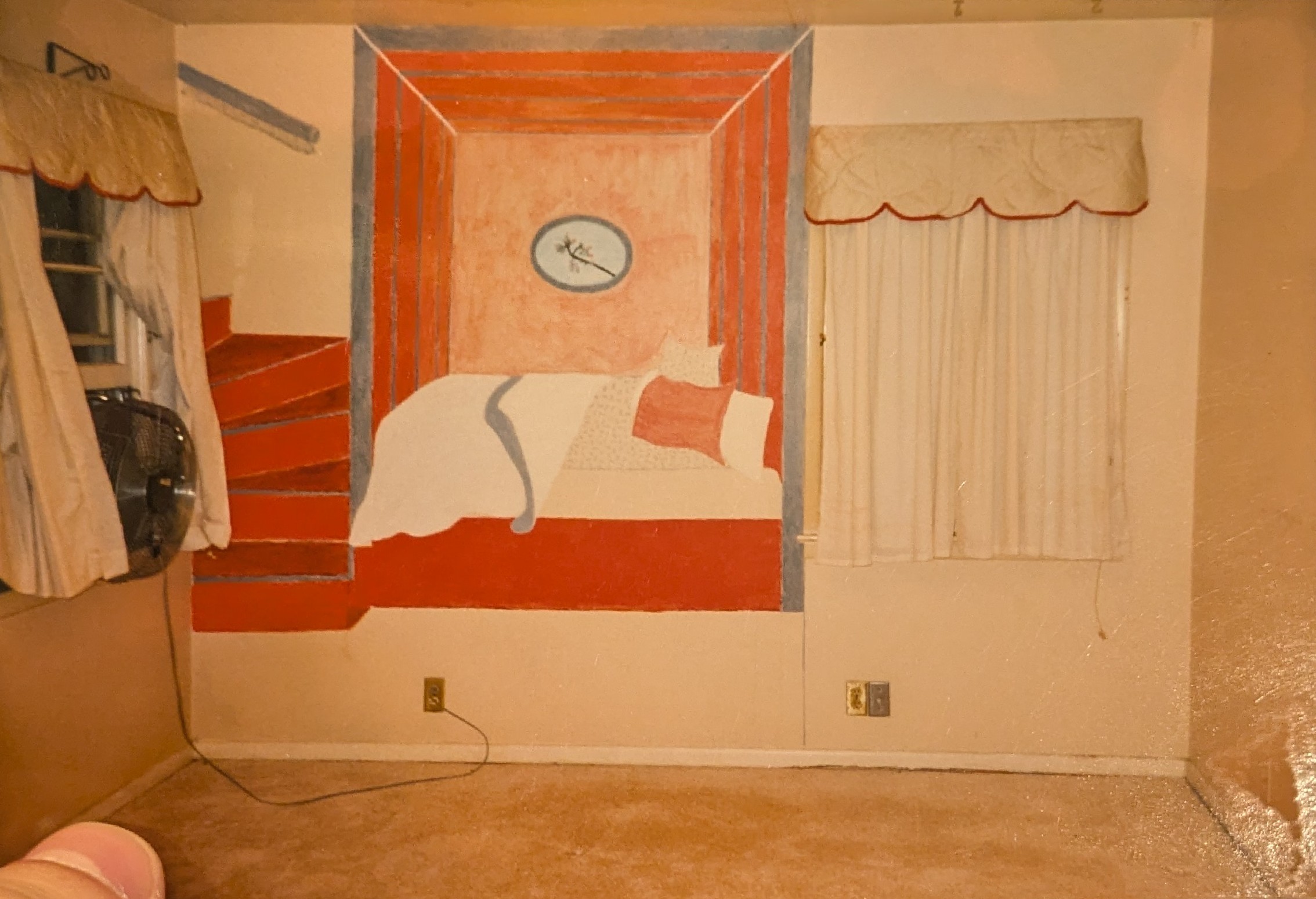 An original wall mural in a bedroom of my parents' house, which they covered shortly after they bought the house in 1995. It features an unmade bed in a red room, with a circular painting of a blooming tree branch above it and a red staircase to its left, turning into nowhere